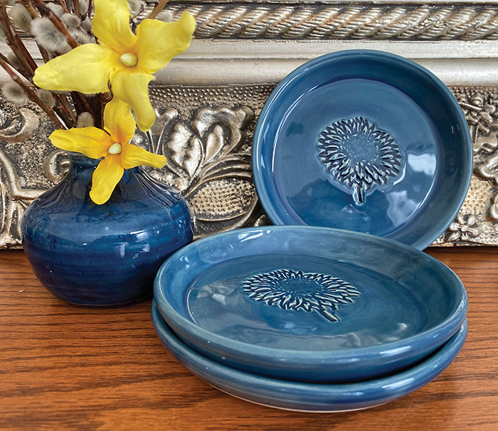 Above are some of the dishes on display. There are two styles of platesone with a solid blue glaze and one with a speckled glaze.<br />
